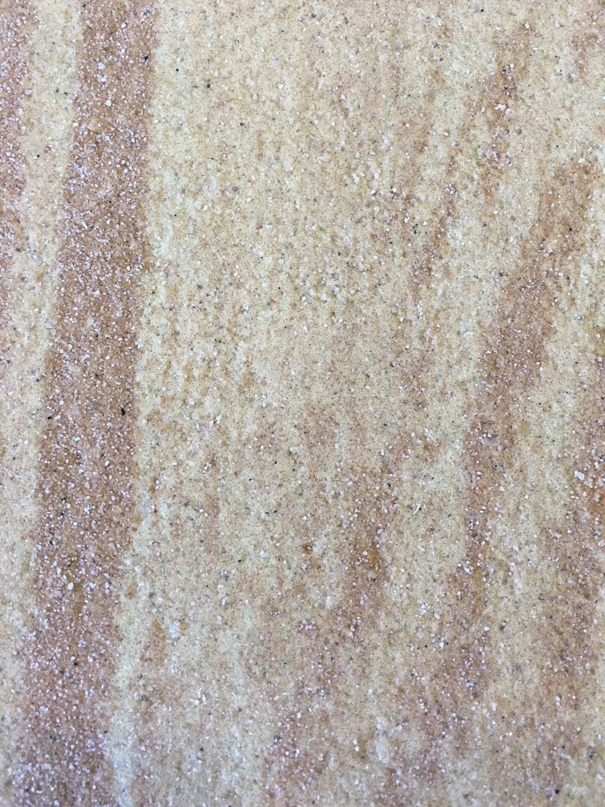 Macro detalle de textura granulada Zoruflex en tonos arena y terracota